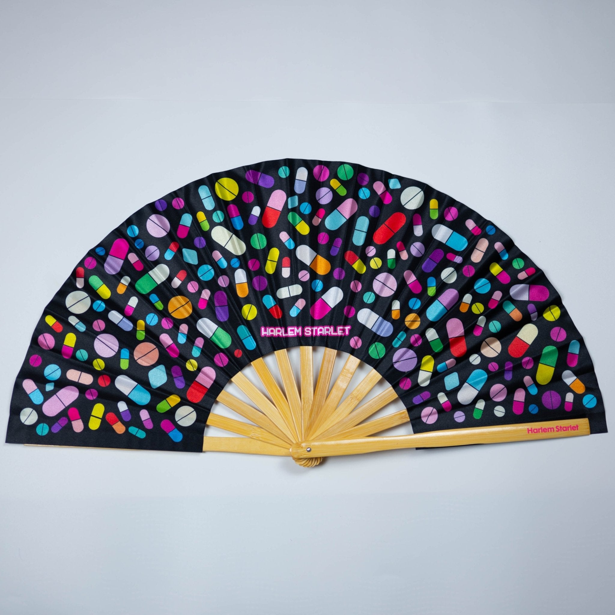 Colorful bamboo fan in Black featuring a rainbow of playful pills, perfect for festivals, raves, doofs and a reminder to take your meds in style.